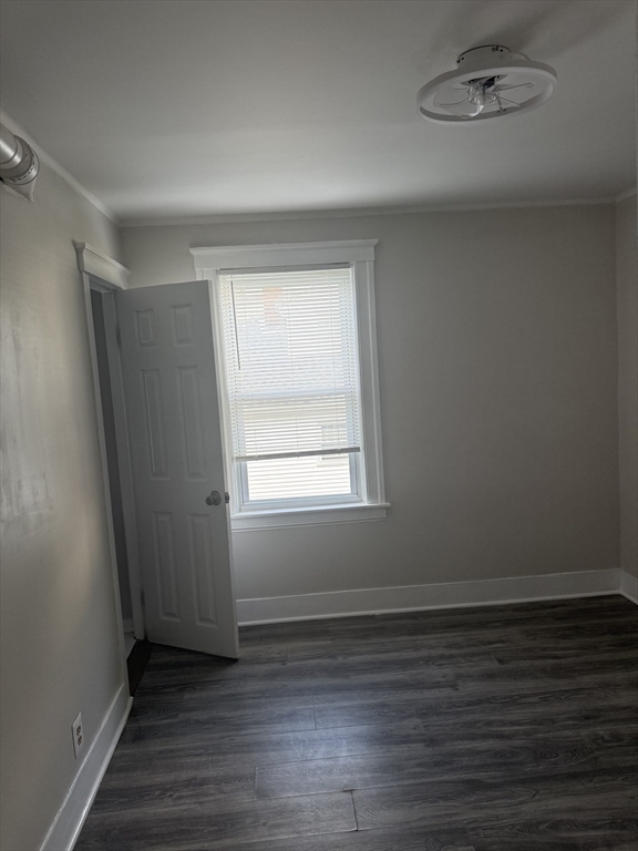 23 Everett Avenue, Unit 1 Webster, MA 01570 - Photo 3 of 9 an empty room with wooden floor and windows