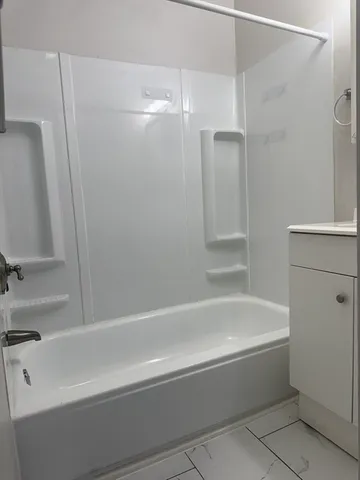 a bathroom with a bathtub and a shower