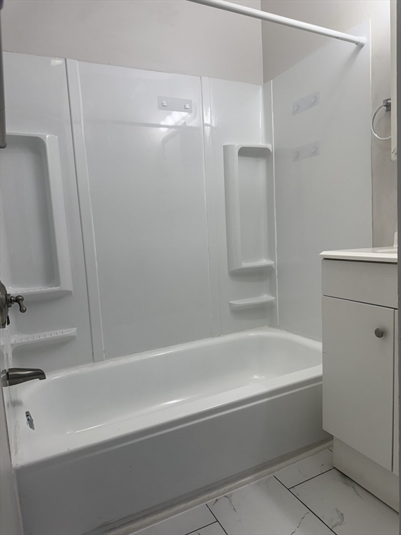 23 Everett Avenue, Unit 1 Webster, MA 01570 - Photo 6 of 9 a bathroom with a bathtub and a shower