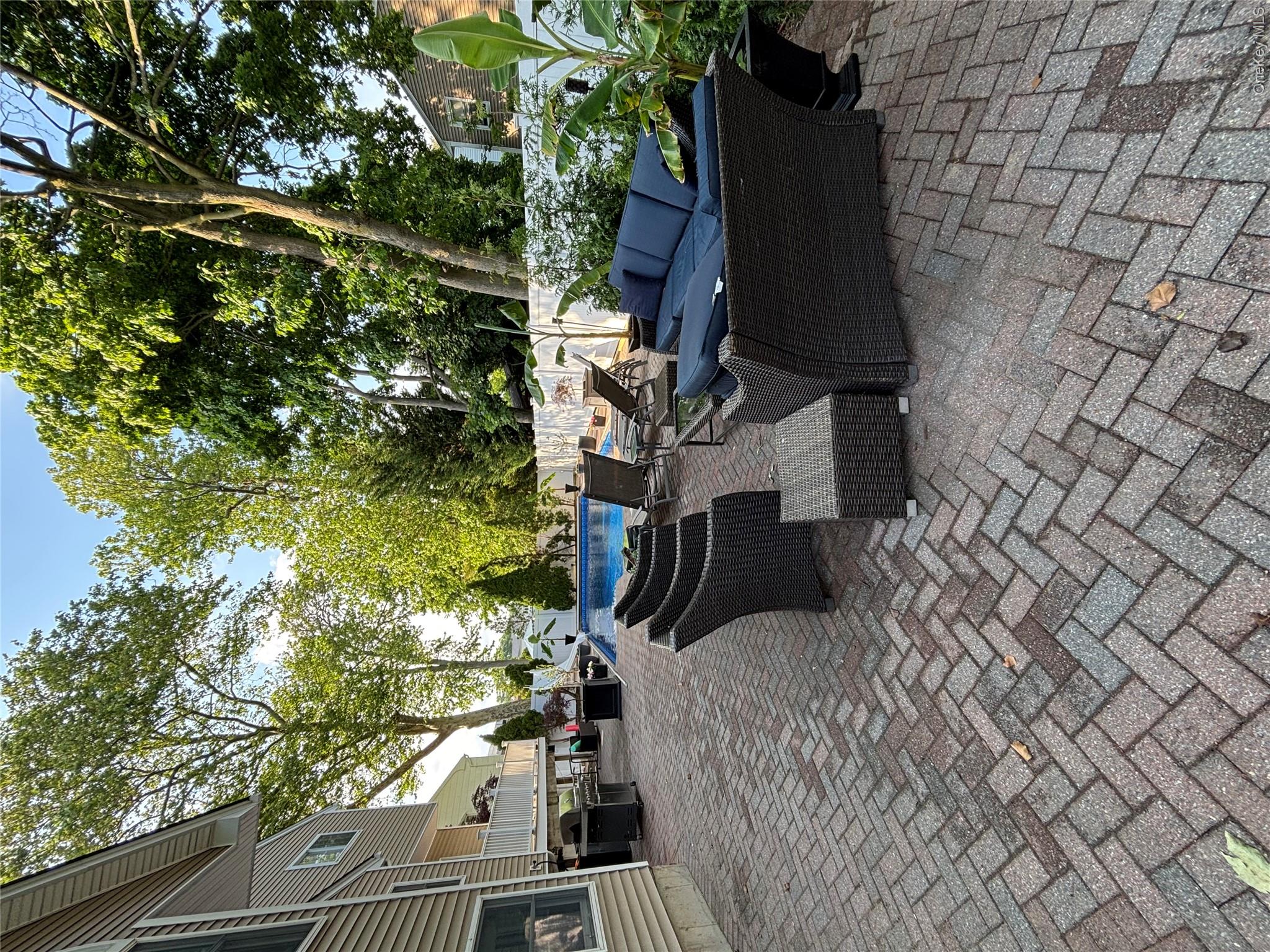 2043 Ripley Lane Merrick, NY 11566 - Photo 40 of 42 a view of a patio with couches and a fire pit