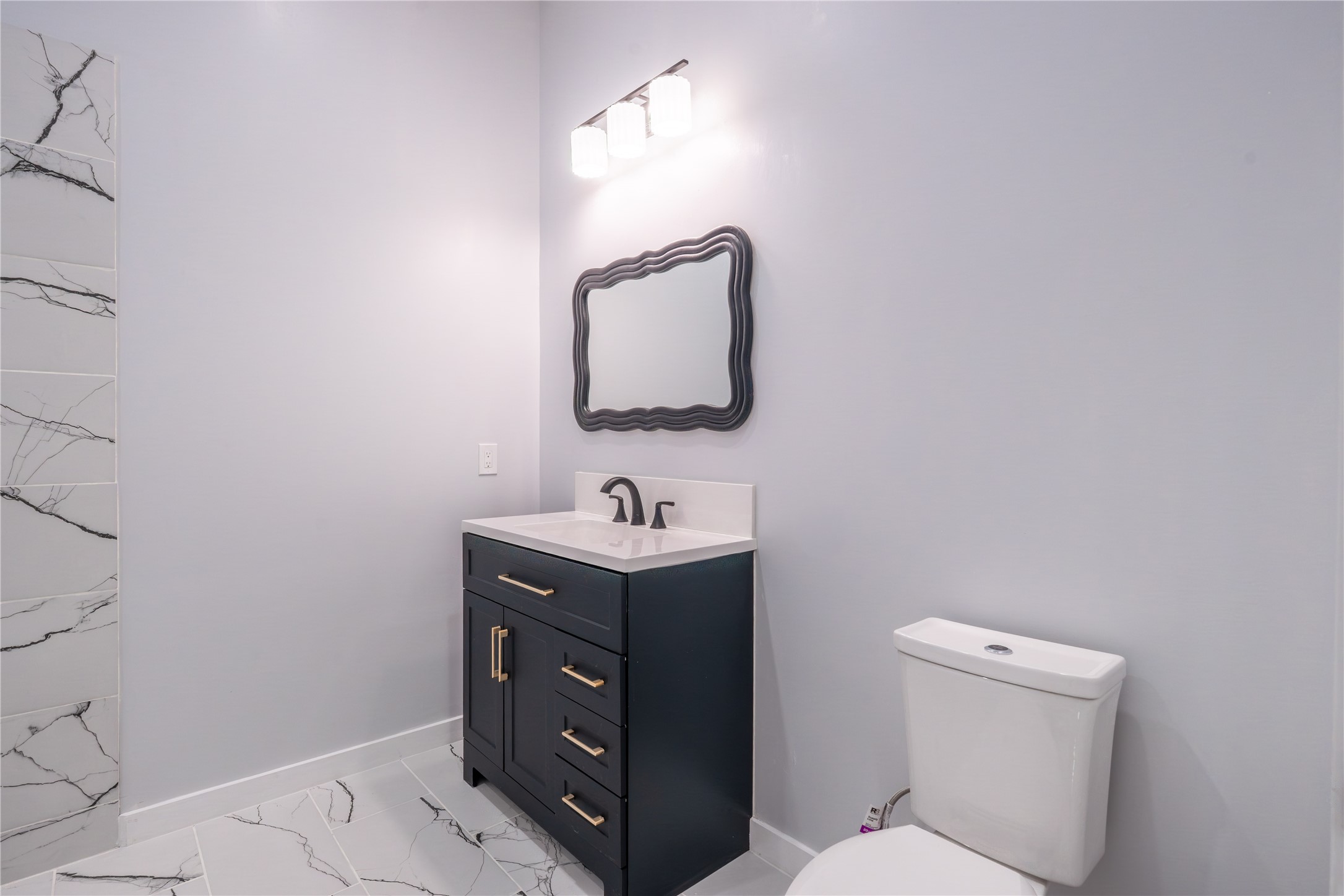 164 County Road 3370 Cleveland, TX 77327 - Photo 17 of 28 a bathroom with a toilet sink vanity and mirror