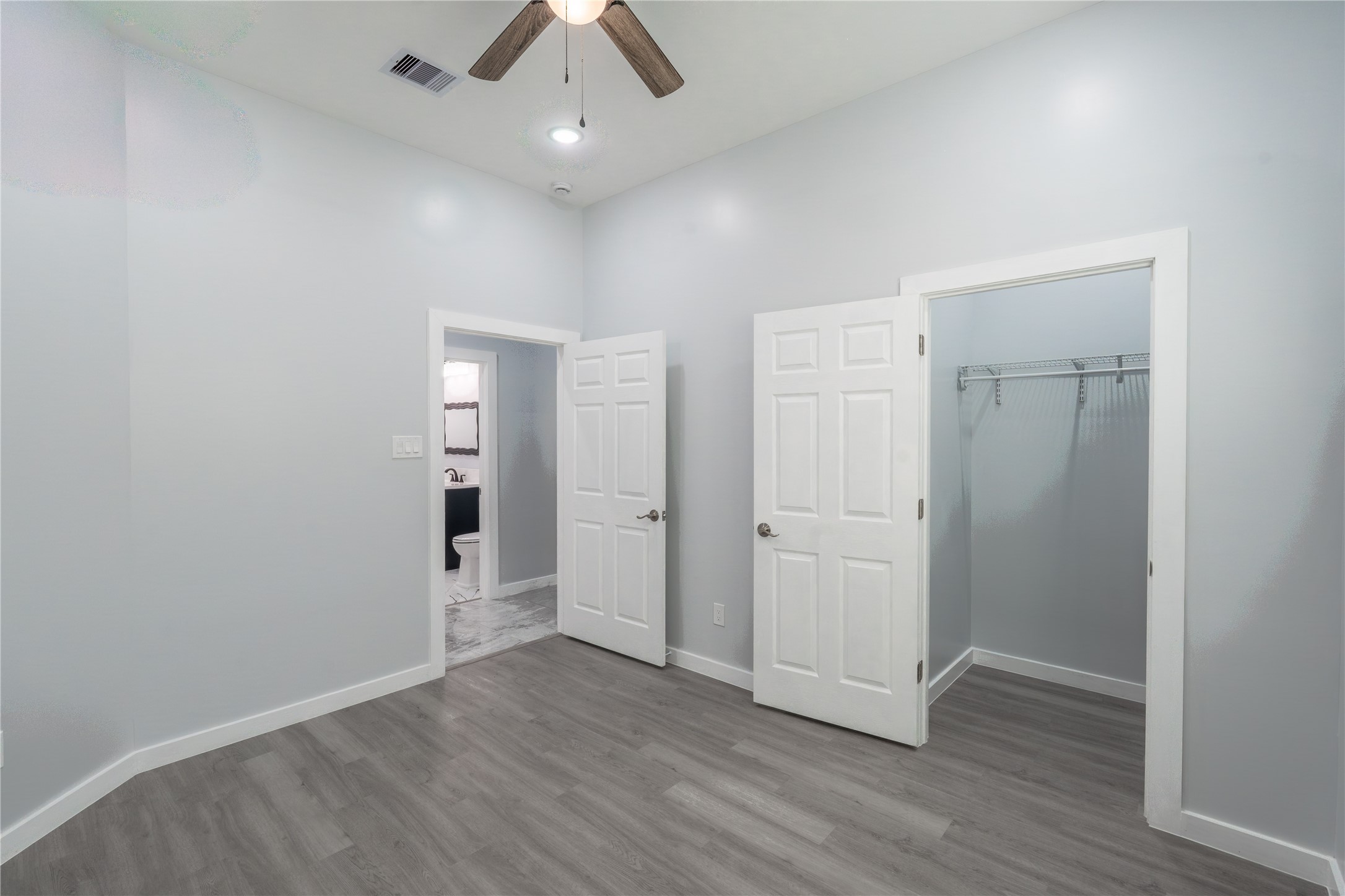 164 County Road 3370 Cleveland, TX 77327 - Photo 19 of 28 an empty room with wooden floor and windows