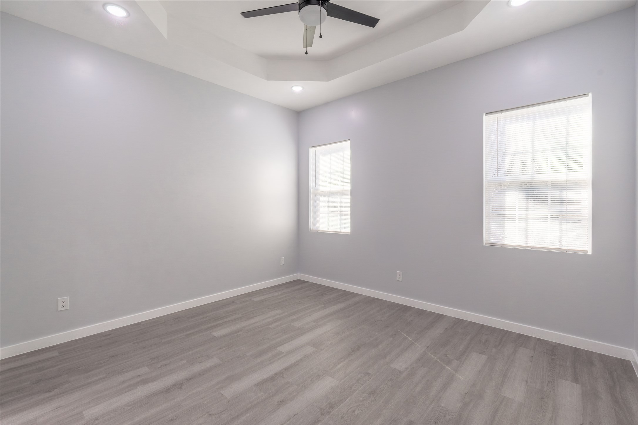 164 County Road 3370 Cleveland, TX 77327 - Photo 20 of 28 an empty room with wooden floor ceiling fan and windows