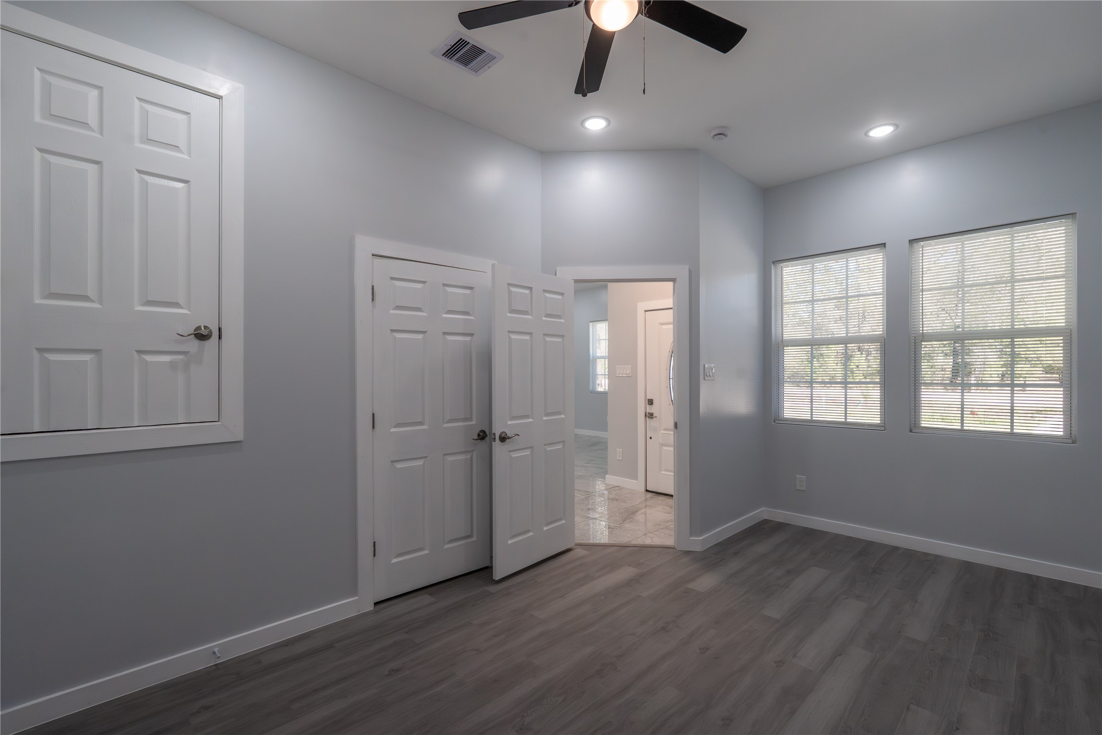 164 County Road 3370 Cleveland, TX 77327 - Photo 23 of 28 an empty room with wooden floor cabinet and windows