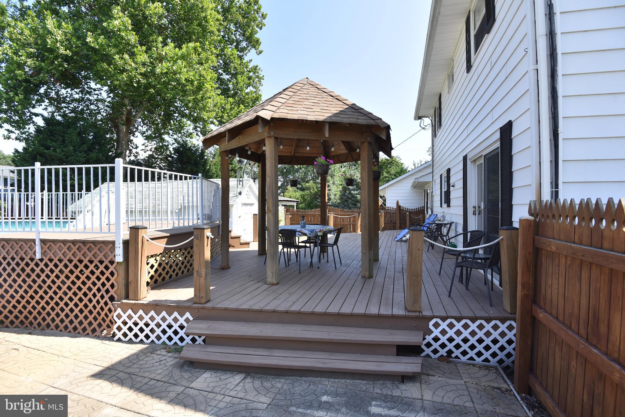 7826 Harbor Road Pasadena, MD 21122 - Photo 15 of 66 Beautifully maintained deck, fence and gazebo.