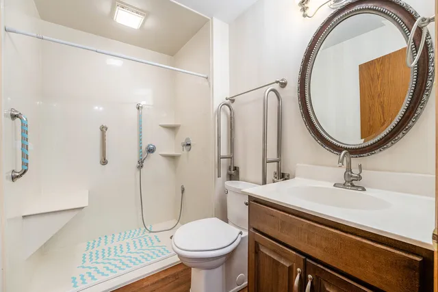 a bathroom with a sink toilet and a mirror