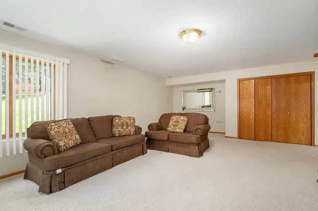 a living room with furniture window and a flat screen tv