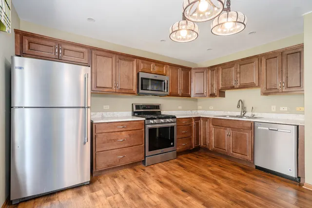 a kitchen with a refrigerator stove and white cabinets