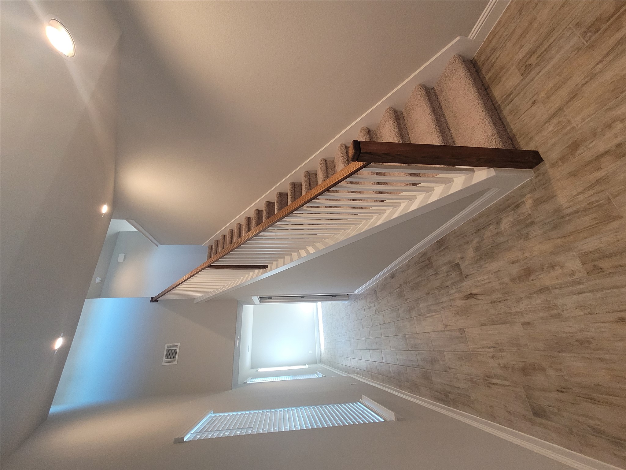 120 Free Stone Drive Georgetown, TX 78628 - Photo 25 of 40 A striking stairway features carpeted treads and a handsome wood and white baluster railing, creating a welcoming ascent.