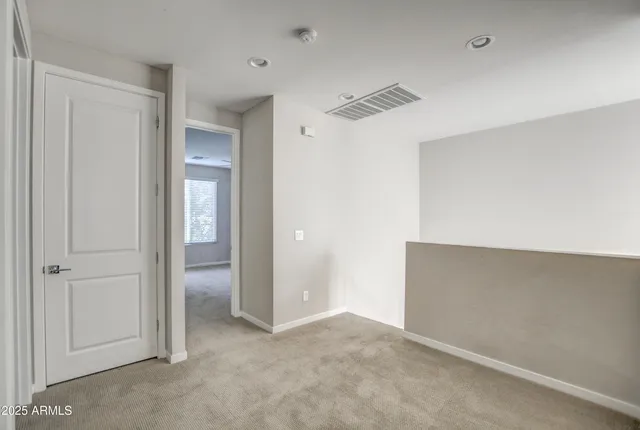 a view of a livingroom with a ceiling fan & entryway