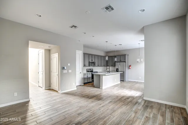 a view of kitchen with sink microwave and cabinets