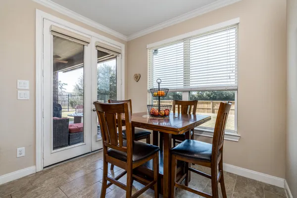a dining room with furniture and window