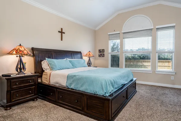 a bed sitting in a bedroom next to a window