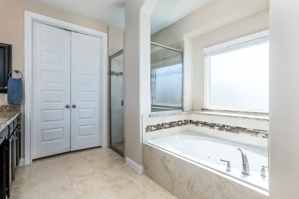 a view of a bathroom with a tub and sink