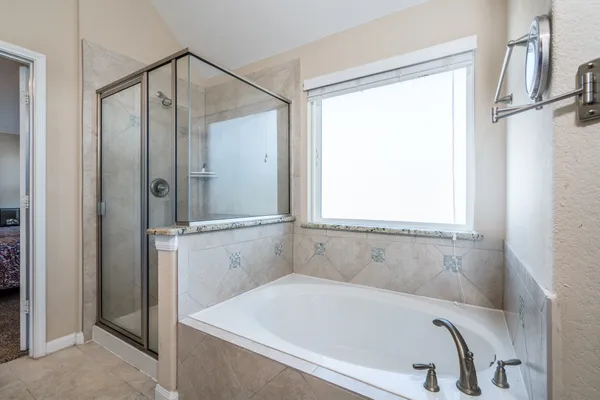 a bathroom with a tub and a shower