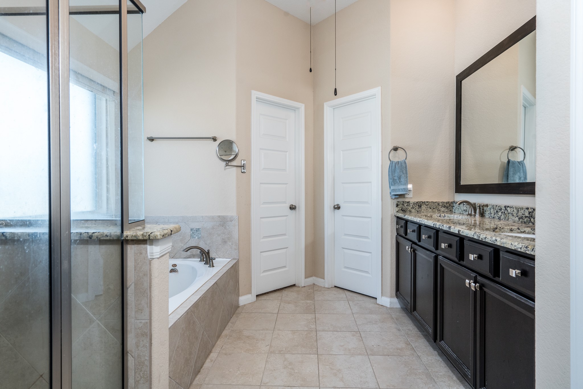 6231 Warwick Garden Lane Spring, TX 77379 - Photo 30 of 50 a bathroom with a granite countertop sink a mirror and a bathtub