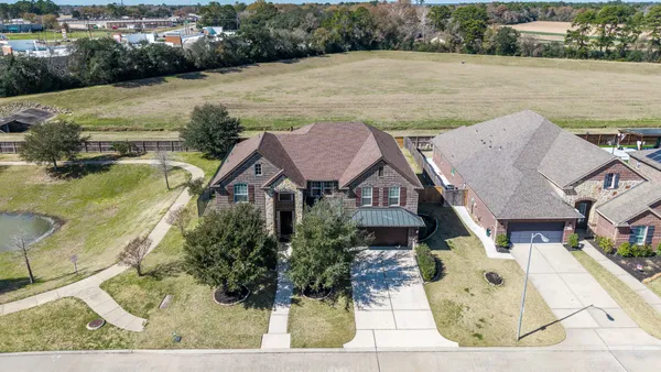 an aerial view of a house with garden space and lake view