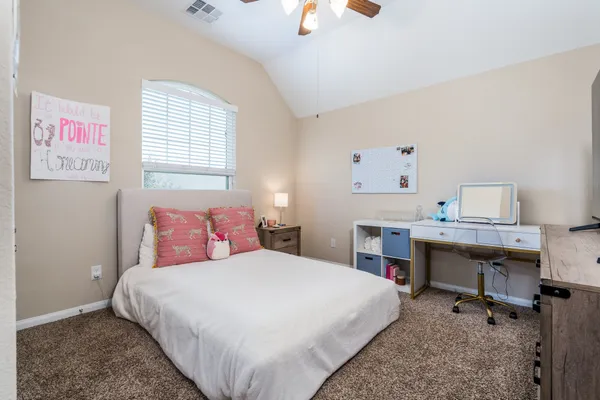 a bedroom with a bed and a desk