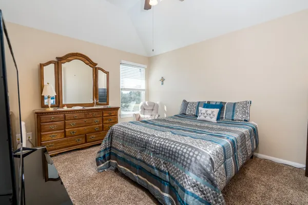 a bedroom with a bed and dresser