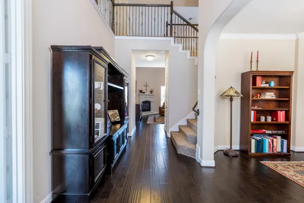 a view of a hallway with wooden floor and staircase