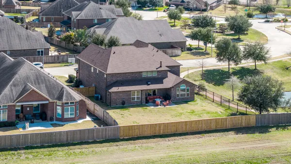 an aerial view of residential houses with yard