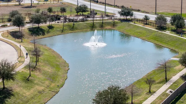 a view of a swimming pool with a yard