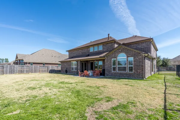 a view of a house with a yard and porch