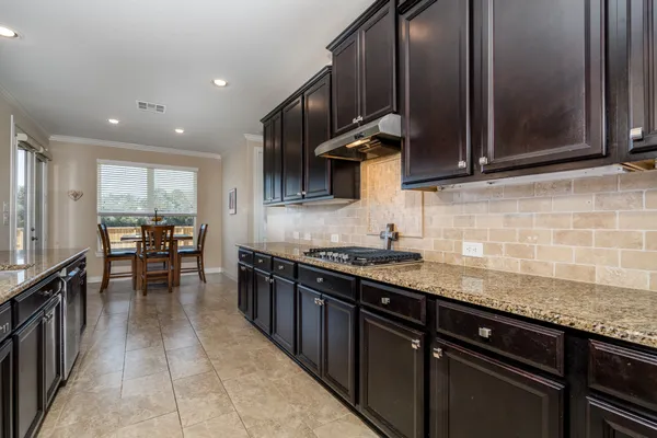a kitchen with stainless steel appliances granite countertop counter space a sink and cabinets