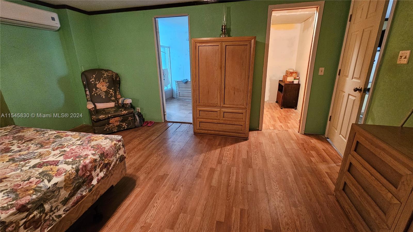 1823 John Road Clewiston, FL 33440 - Photo 14 of 34 a room with wooden floor and furniture