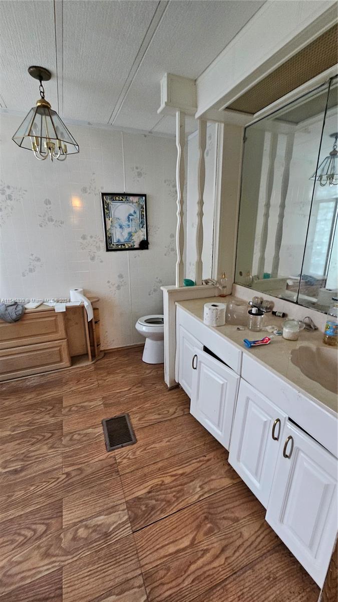 1823 John Road Clewiston, FL 33440 - Photo 17 of 34 a spacious bathroom with a granite countertop sink and a mirror