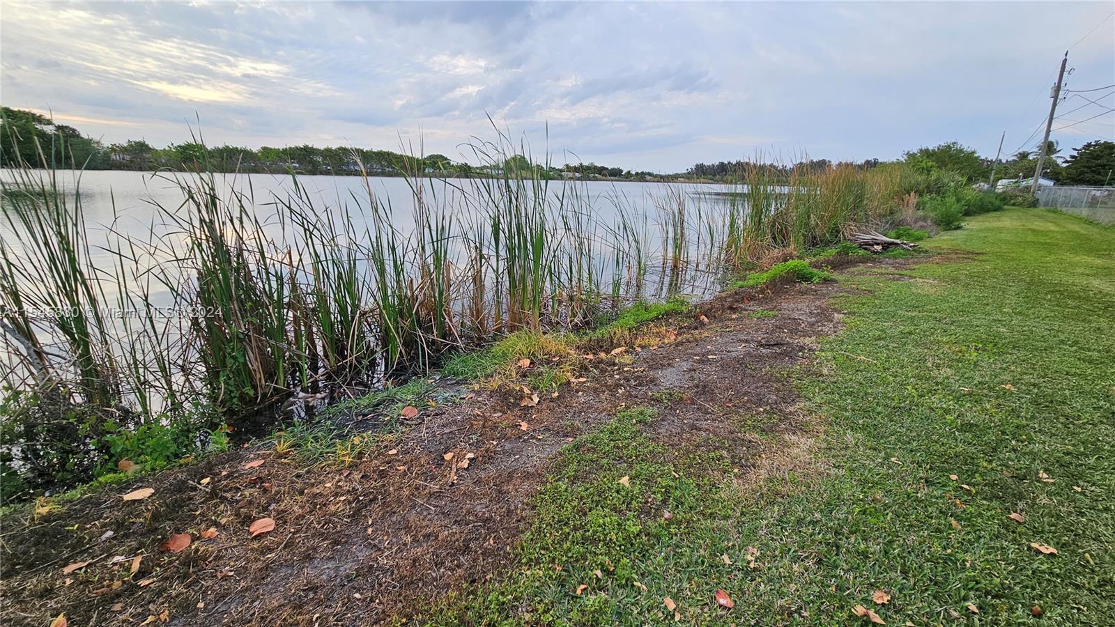 1823 John Road Clewiston, FL 33440 - Photo 34 of 34 a backyard of a house with lots of green space and lake view
