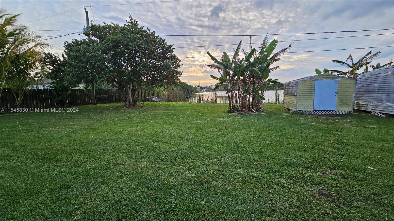 1823 John Road Clewiston, FL 33440 - Photo 4 of 34 a view of a house with a big yard and large trees