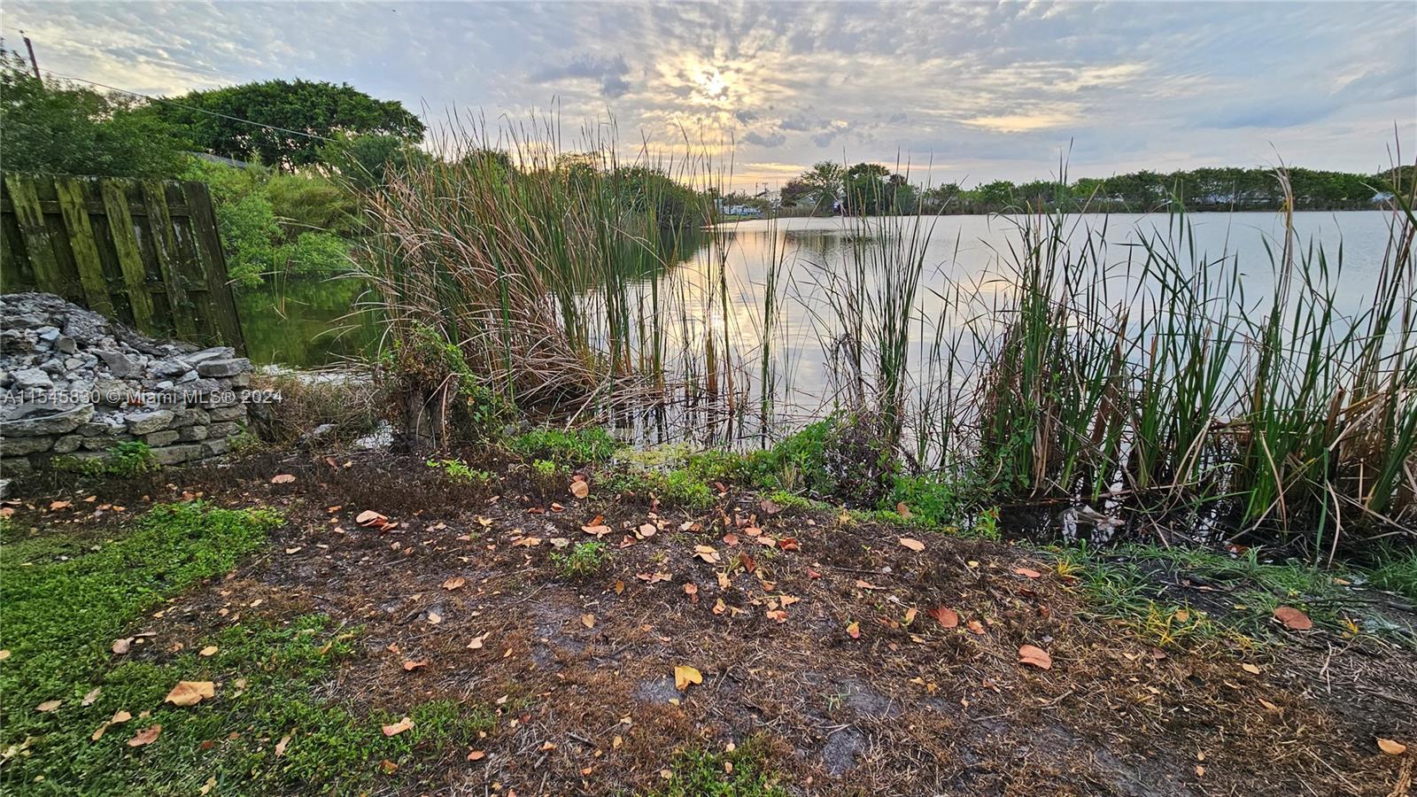 1823 John Road Clewiston, FL 33440 - Photo 6 of 34 a view of lake with wooden stairs