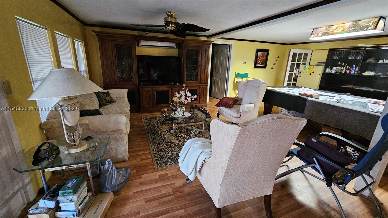 1823 John Road Clewiston, FL 33440 - Photo 7 of 34 a living room with furniture a flat screen tv and a fireplace