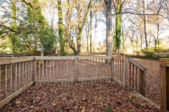 a view of a yard with plants and trees