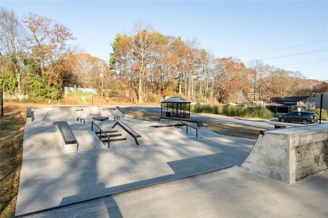 a view of a swimming pool with a lawn chairs under an umbrella