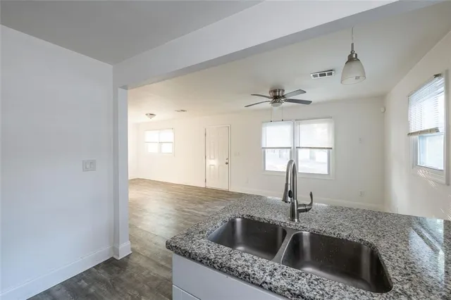 a kitchen with a refrigerator and a stove