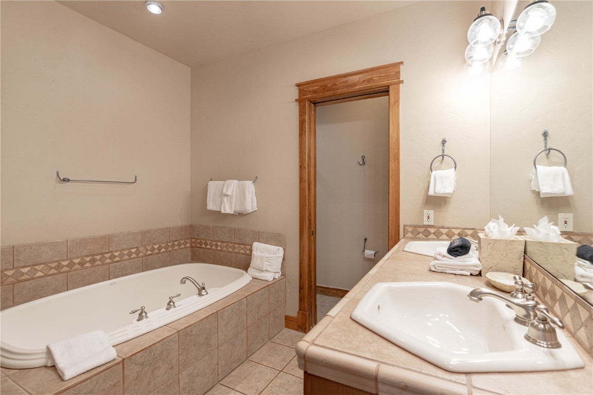 71 Cucumber Patch Placer Road, Unit 7 Breckenridge, CO 80424 - Photo 14 of 21 a bathroom with a tub sink and mirror