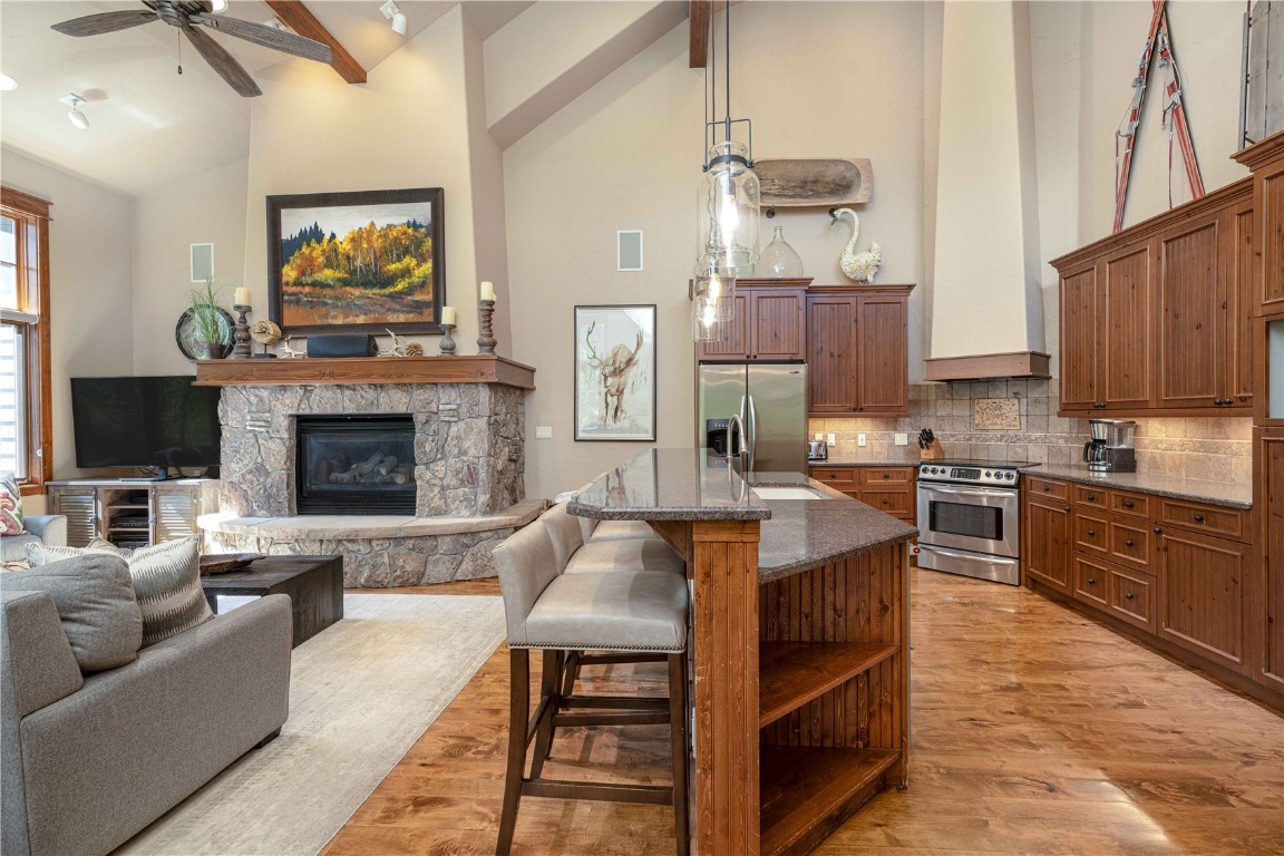 71 Cucumber Patch Placer Road, Unit 7 Breckenridge, CO 80424 - Photo 4 of 21 a living room with stainless steel appliances furniture a fireplace a flat screen tv and kitchen view