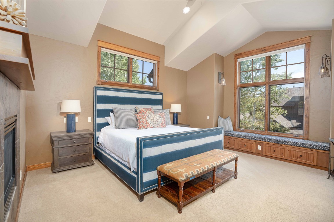 71 Cucumber Patch Placer Road, Unit 7 Breckenridge, CO 80424 - Photo 9 of 21 a bedroom with a bed and a large window