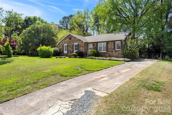 a front view of a house with yard and green space