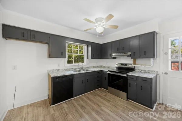 a kitchen with a sink stove and cabinets