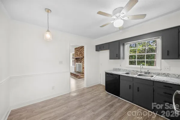 a view of a kitchen with a sink cabinet and a window