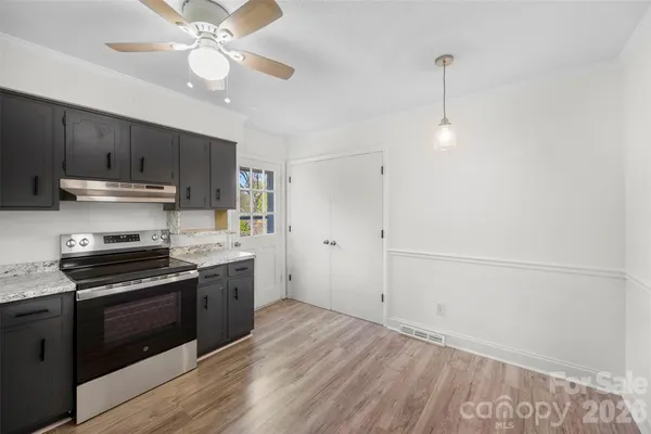 a kitchen with a sink stainless steel appliances and cabinets