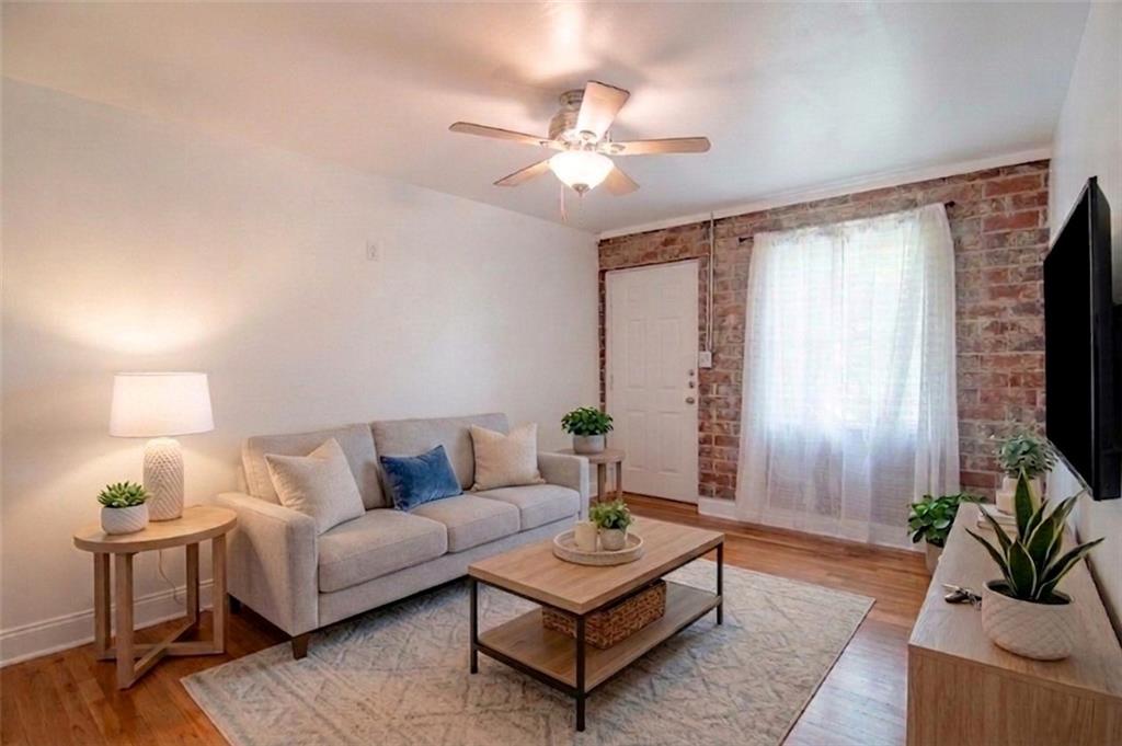 24 Daniel Street Southeast, Unit 8 Atlanta, GA 30312 - Photo 12 of 29 a living room with furniture a chandelier and a flat screen tv