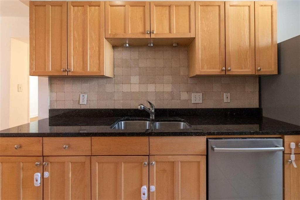 24 Daniel Street Southeast, Unit 8 Atlanta, GA 30312 - Photo 15 of 29 a kitchen with granite countertop a stove a sink and a microwave