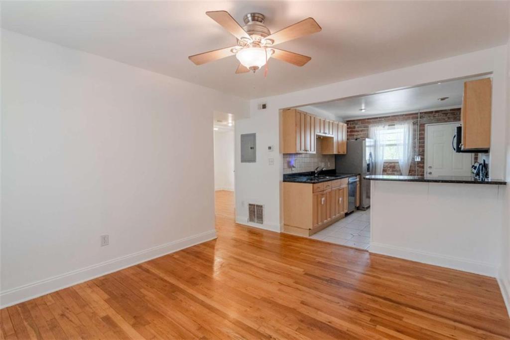 24 Daniel Street Southeast, Unit 8 Atlanta, GA 30312 - Photo 5 of 29 a kitchen with granite countertop a stove cabinets and wooden floor
