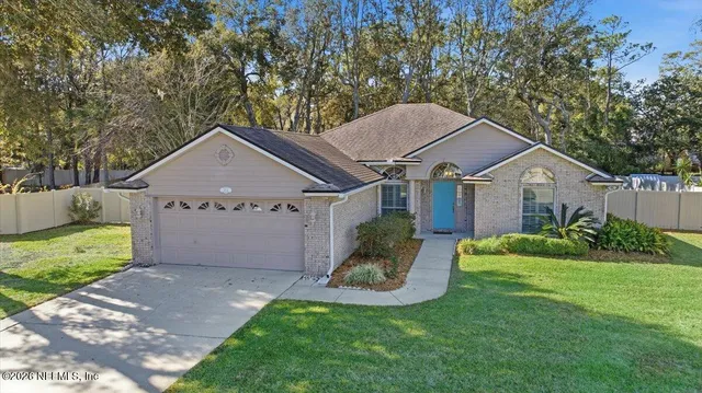 a view of a house with a yard and a garden