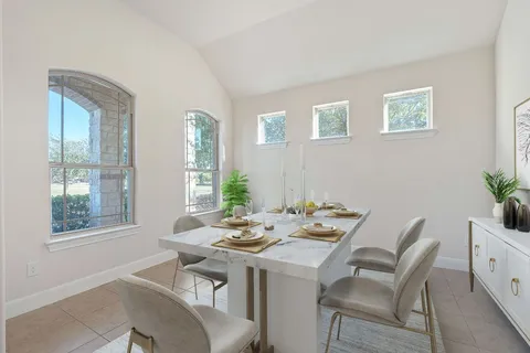 a dining room with furniture and window