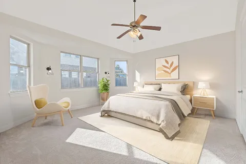 a spacious bedroom with a bed and a chandelier